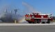 Kyle Rudolph, Minnesota Vikings tight end, operates a water cannon on an 86th Civil Engineer Squadron firetruck to extinguish flames surrounding a mock C-130 on Ramstein Air Base, Germany, April 6, 2018. As one of the largest firehouses in the U.S. Air Force, firefighters from the 86th CES routinely participate in readiness exercises and play a vital role in the Ramstein mission.