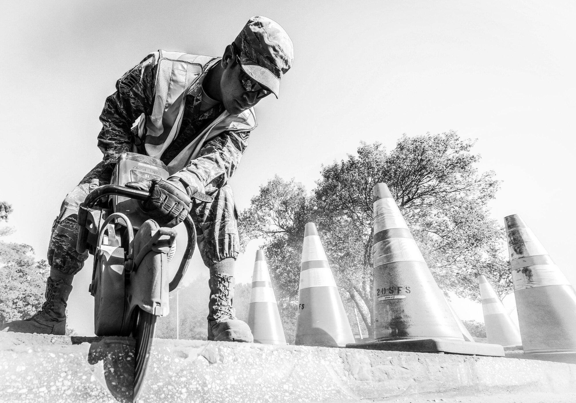 U.S. Air Force Staff Sgt. Jacob Robinson, 20th Civil Engineer Squadron pavement and construction journeyman, uses a K-12 saw to cut through asphalt at Shaw Air Force Base, S.C., April 12, 2018.