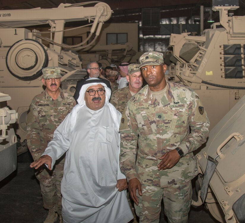 Lt. Col. Michael T. Jordan, commander, Army Field Support Battalion- Kuwait, gives Shaykh Nasser, First Deputy Prime Minister and Minister of Defense Kuwait, a tour of an Army Prepositioned Stocks-5 warehouse at Camp Arifjan, Kuwait, April 11, 2018. The tour provided the minister with an overview of standard Army equipment, maintenance and cost efficiencies for Army vehicles.