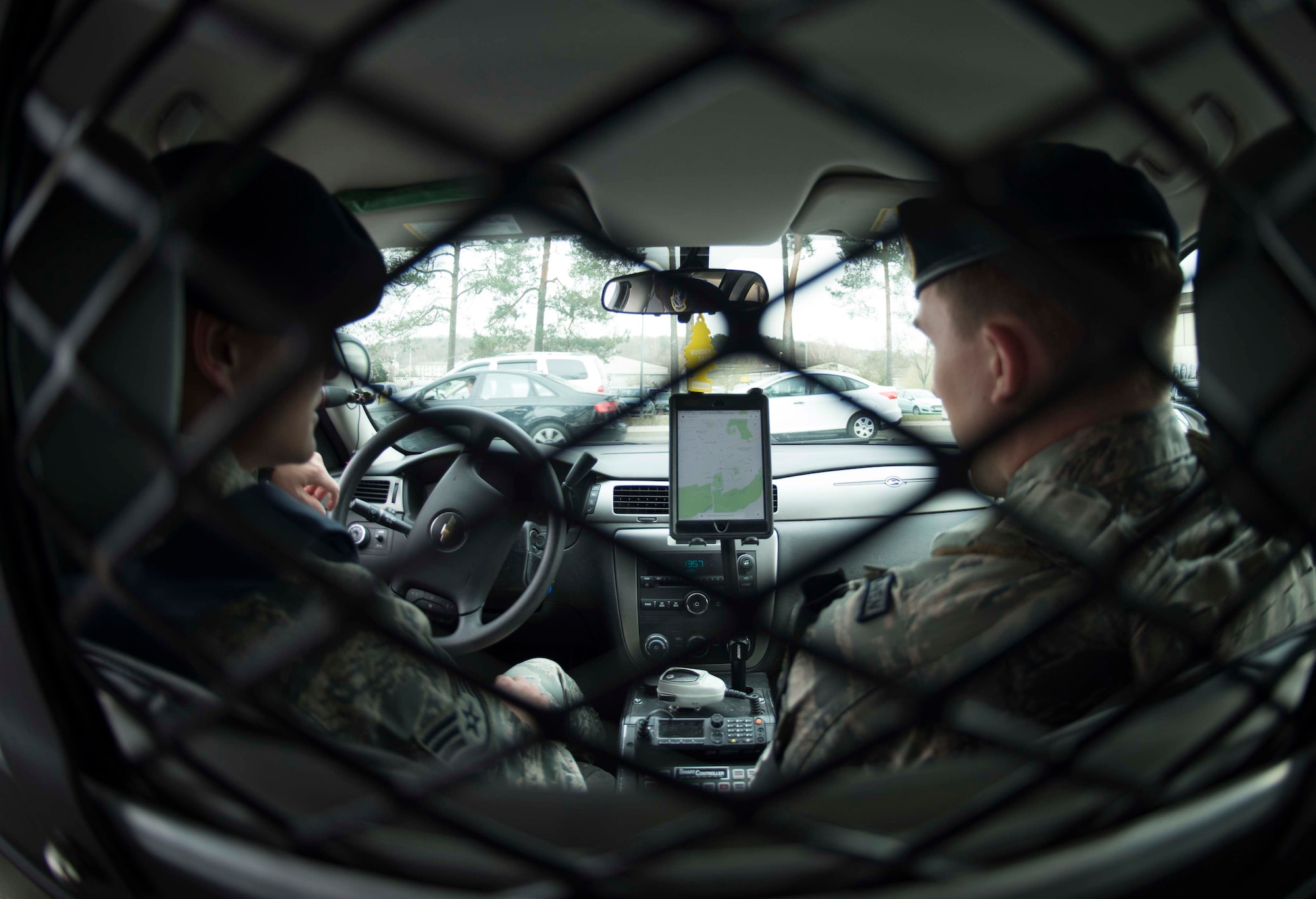 U.S. Air Force Staff Sgt. Ian Metcalf, left, and Senior Airman Nicholas Miller, 569th United States Forces Police Squadron desk patrolmen, use a tablet and satellite tracking application to locate other patrolmen on Vogelweh Military Complex, Germany, March 9, 2018. The 569th USFPS uses tablets installed with three applications to locate the nearest patrolman to an incident and notify them, cutting response time. That saves money, hours, and, most importantly, lives. (U.S. Air Force photo by Senior Airman Elizabeth Baker)