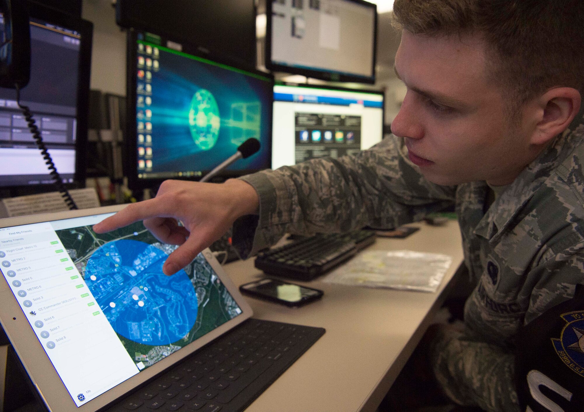 U.S. Air Force Senior Airman Zachary Robertson, 569th United States Forces Police Squadron desk controller, uses a tablet and satellite tracking application to perform the same function of a much more expensive system on Vogelweh Military Complex, Germany, March 9, 2018. The innovation is saving the 569th USFPS an estimated $286,200 and 369 man hours per fiscal year. (U.S. Air Force photo by Senior Airman Elizabeth Baker)