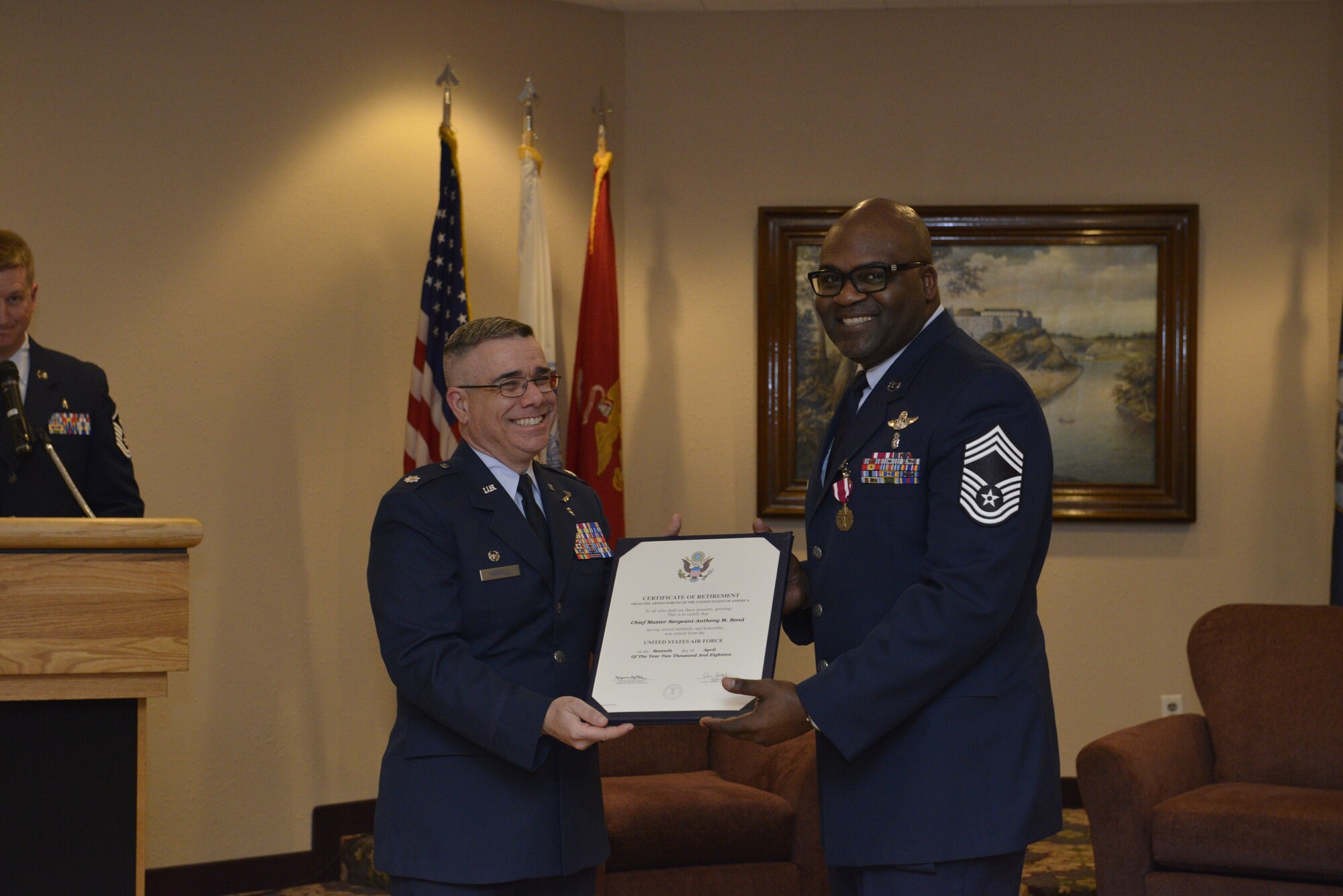 Chief Master Sgt. Anthony Bond accepts his retirement certificate April 7 from Lt. Col. Matthew Hendell, 934th Aeromedical Evacuation Squadron commander, at the Minneapolis St. Paul Air Reserve Station, Minn. (Air Force Photo/Staff Sgt. Amber Jacobs.)