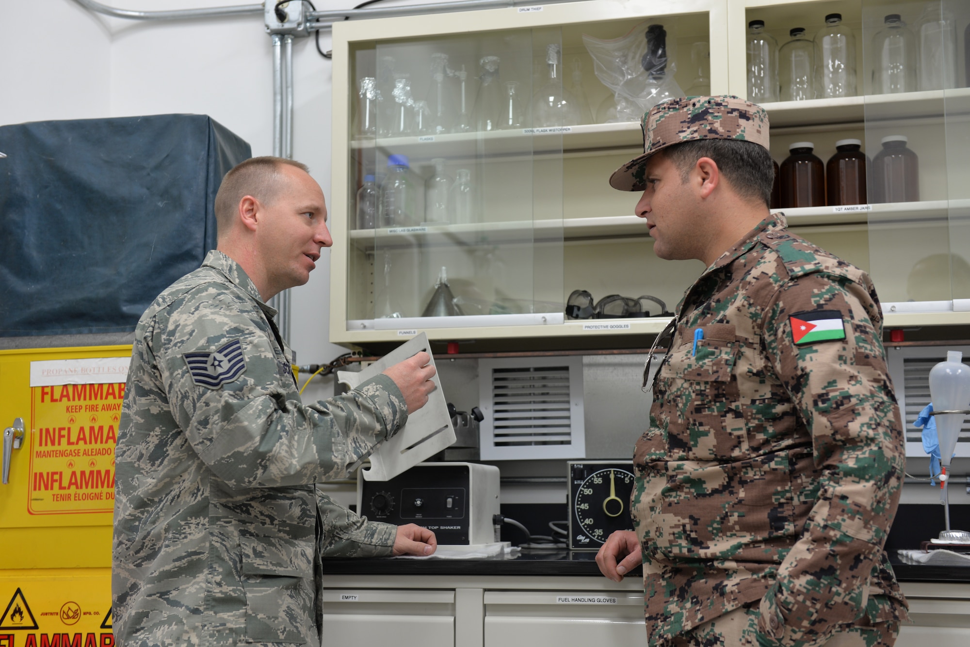 Two Airmen discussing fuel lab operations