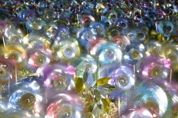 Pinwheels swirl in front of the Keesler Medical Center at Keesler Air Force Base, Mississippi, April 11, 2018. Members of the 81st Medical Operations Squadron family advocacy and volunteers placed pinwheels to individually represent children in the three area counties who were victims of child abuse or neglect last year. April is National Child Abuse Prevention Month, which focuses on how to prevent child abuse and neglect as well as promoting child and family well-being. (U.S. Air Force photo by Kemberly Groue)