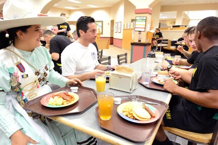 Charro Queen Victoria Rodriguez (left) and Rey Feo LXX Kenneth Flores join Soldiers assigned to the 187th Medical Battalion for breakfast after the 32nd Medical Brigade Enlisted Run at Joint Base San Antonio-Fort Sam Houston in the early morning hours April 13.