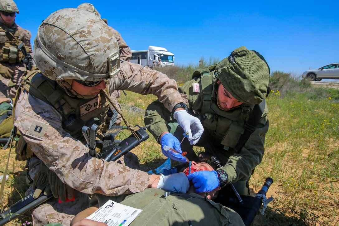 ISRAEL (March 13, 2018) U.S. Navy Lt. Chandler Getz, the for Battalion Landing Team 2nd Battalion, 6th Marine Regiment (BLT 2/6) surgeon, 26th Marine Expeditionary Unit (MEU), and a medic with the Israeli Defense Forces treat a notional casualty during a mass-casualty training exercise as part of exercise Juniper Cobra, March 12, 2018.