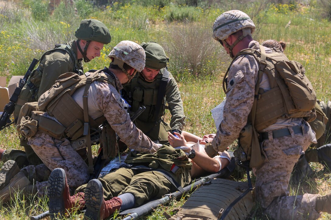 ISRAEL (March 13, 2018) U.S. Navy Sailors assigned to Battalion Landing Team, 26th Marine Expeditionary Unit, and medics with the Israeli Defense Forces treat a notional casualty during a mass-casualty training exercise as part of exercise Juniper Cobra, March 12, 2018. The 26th MEU is participating in Juniper Cobra with the Israeli Defense Force in order to improve interoperability and hone both forces’ skills in a variety of environments. (U.S. Marine Corps photo by Cpl. Jon Sosner/Released)