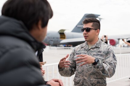 U.S. Air Force Staff Sergeant Humberto Morales, 56th Operations Support Squadron Aircrew Flight Equipment Journeyman, Luke Air Force Base, Arizona, participates in a discussion with members of the Chilean public during the FIDAE 2018 international airshow in Santiago, Chile, April 6, 2018.  U.S. airmen participated in a variety of activities during the air show, including subject matter exchanges with the Chilean Air Force, aerial demonstrations, and interaction with the local community.  (U.S. Air Force photo by Staff Sgt. Danny Rangel)
