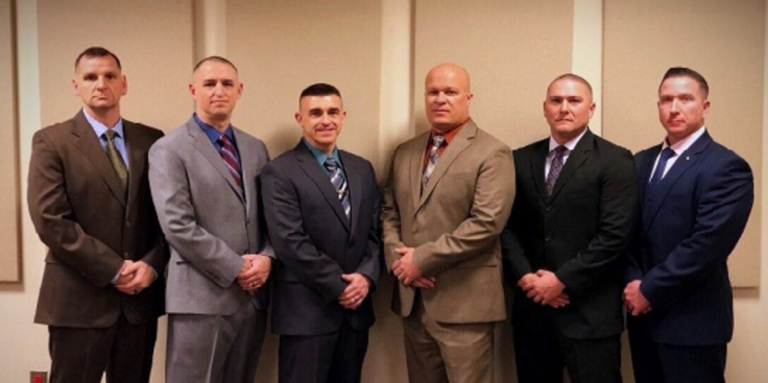 The Marine Corps Recruiting Command National Training Team (NTT) pauses to take a photo in between teaching courses at the National Conference Center in Leesburg, Virginia, April 9, 2018. The NTT writes curriculums for recruiters and other units who 
need assistance, including the Basic Recruiter Course, Career Recruiter School, Recruiter Management Course and hostage negotiation curriculums. The team trains more than three thousand recruiters as well as other units to effectively recruit civilians to join the Marine Corps or the Marine Corps Reserve, or execute a mission.