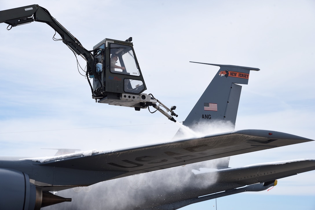 A 108th Maintenance Group Airman de-ices the wing of a KC-135R Stratotanker on the 108th Wing's flightline at Joint Base McGuire-Dix-Lakehurst, N.J., March 22, 2018. The northeast region of the U.S. was hit with its fourth snow storm on the first day of spring. (U.S. Air National Guard photo by Senior Airman Julia Santiago/Released)