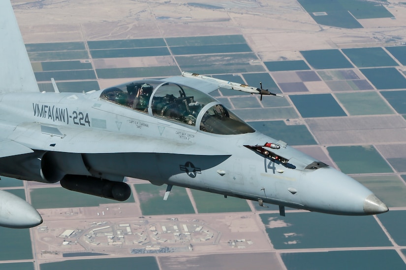 An F/A-18 Hornet aircraft from Marine Corps Fighter Attack Squadron 224 prepares to receive fuel from a KC-130J Hercules aircraft.