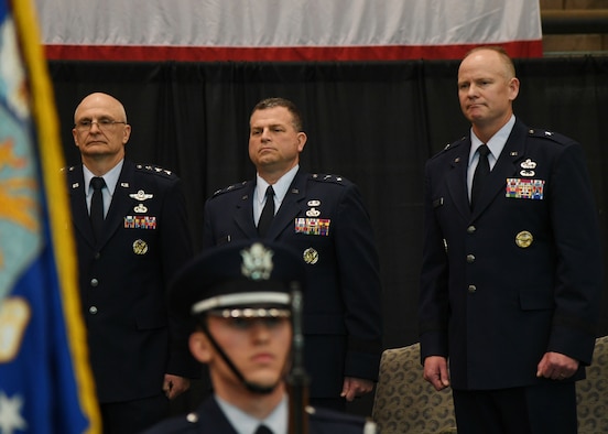 Brig. Gen. Michael Schmidt, right, takes leadership of the Command, Control, Communications, Intelligence and Networks directorate at Hanscom Air Force Base, Mass., April 13, 2018 from Maj. Gen. Dwyer Dennis, center, who is retiring, during a ceremony at hosted by Lt. Gen. Arnold Bunch, left, military deputy of the Office of Assistant Secretary of Air Force for Acquisition at the Pentagon. The change of leadership ceremony was held at the Hanscom Aero Club hangar.  (U.S. Air Force Photo by Linda LaBonte Britt)