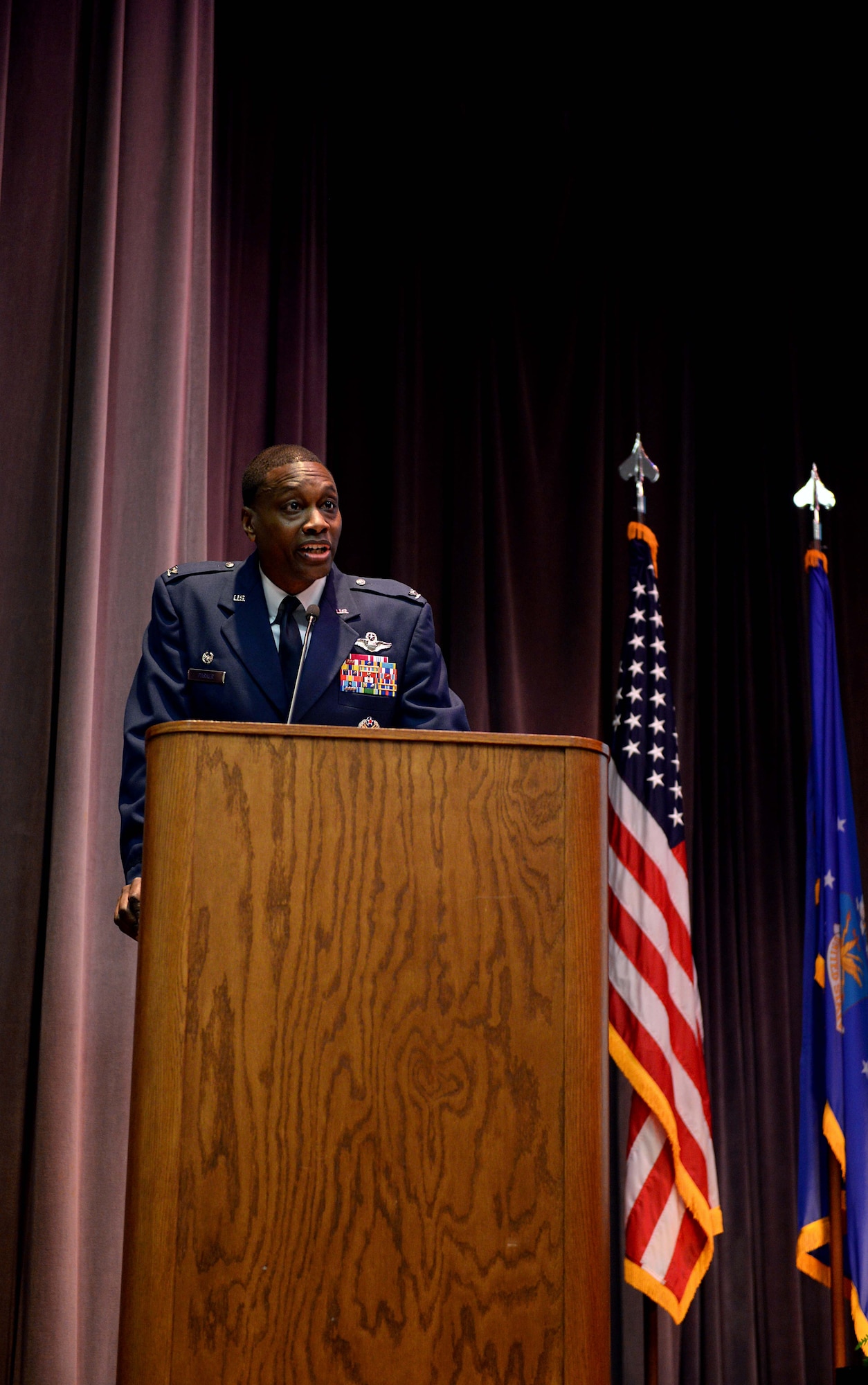 Col. Brandon Parker, 7th Bomb Wing commander at Dyess Air Force Base, Texas, speaks during Specialized Undergraduate Pilot Training Class 18-07’s graduation ceremony April 6, 2018, on Columbus Air Force Base, Mississippi. His speech focused on the symbolism of the wings all aircrew wear. He charged the students with three tasks throughout their Air force careers: educate, innovate and motivate. (U.S. Air Force photo by Airman 1st Class Keith Holcomb)