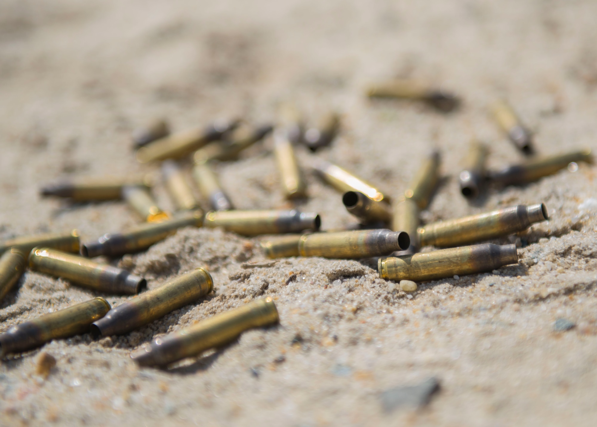 Spent M-16 rifle ammunition casings lie on the ground at Joint Base Langley-Eustis, Virginia., April 11, 2018. The NCO of the Year and Soldier of the Year competitors battled for top shooter during the M-16 rifle exercise. (U.S. Air Force photo by Airman 1st Class Monica Roybal)