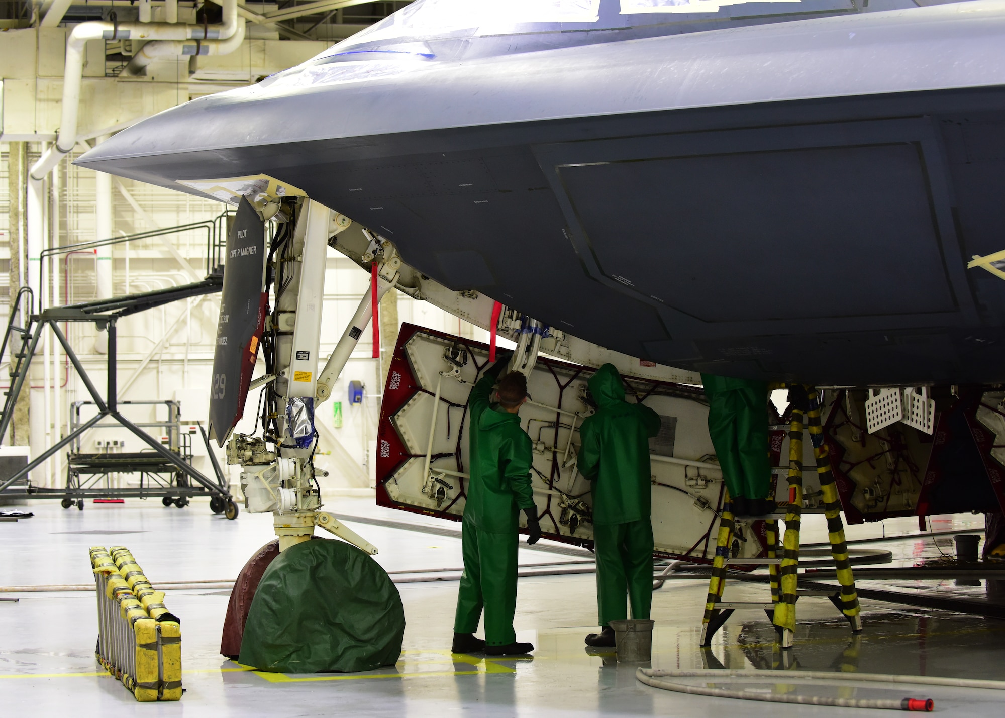 Crew chiefs assigned to the 509th Aircraft Maintenance Squadron finish wiping down the inside of a panel of a B-2 Spirit during a wash at Whiteman Air Force Base, Mo., April 10, 2018. Each square inch of the B-2 is carefully inspected while a wash is being conducted to ensure the aircraft is mission ready once it is completely cleaned. (U.S. Air Force photo by Staff Sgt. Danielle Quilla)