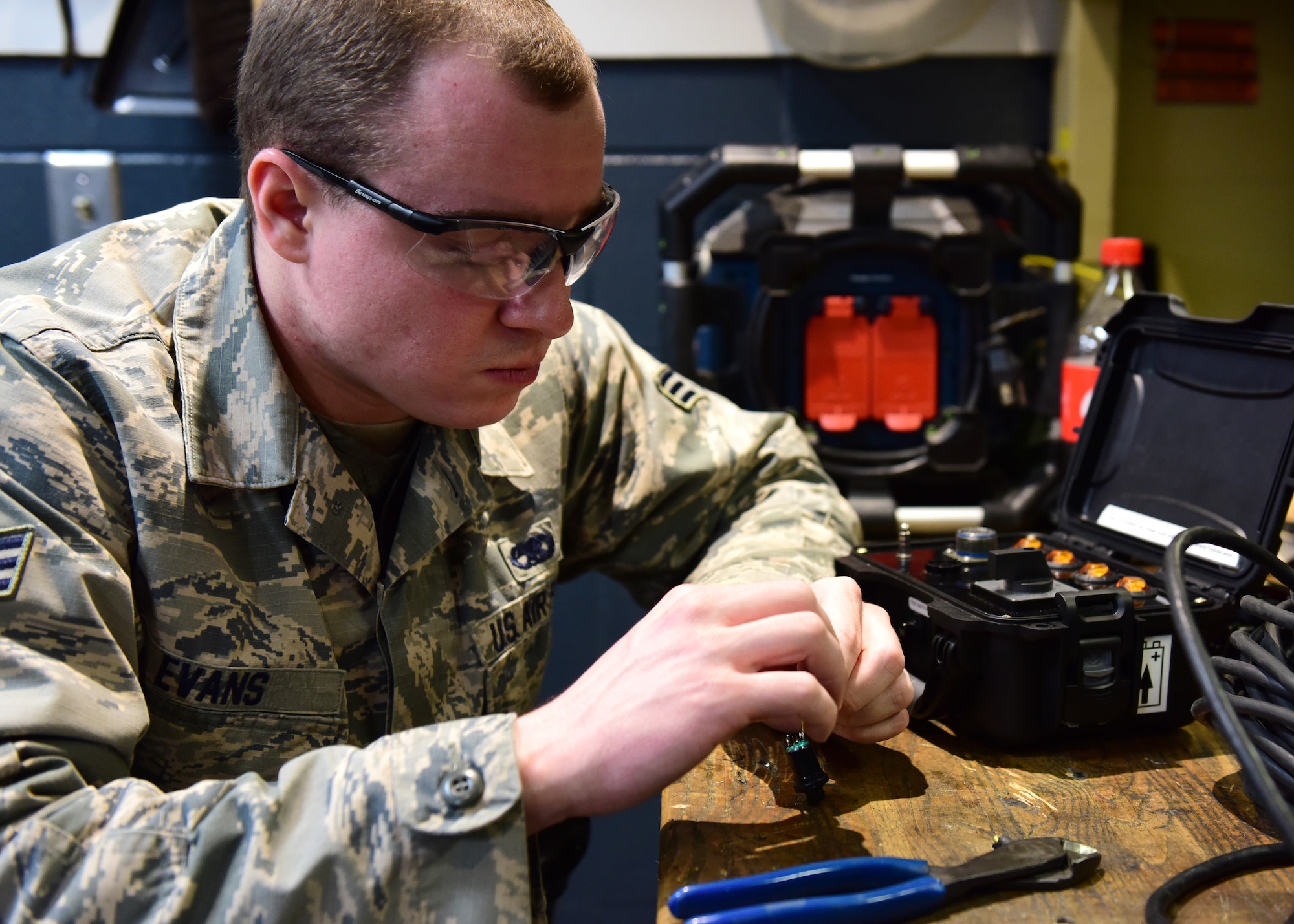 U.S. Air Force Senior Airman Cody Evans, a composite tool kit technician assigned to the 509th Aircraft Maintenance Squadron, fixes communication equipment at Whiteman Air Force Base, Mo., April 10, 2018. The members of the 509th AMXS are responsible for day-to-day maintenance of the B-2 Spirit. (U.S. Air Force photo by Staff Sgt. Danielle Quilla)