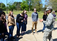 Airman 1st Class Rodney Williams, 14th Operations Support Squadron aviation resource manager, greets the Lowndes Young Leaders during a base tour April 10, 2018, on Columbus Air Force Base, Mississippi. Lowndes Young Leaders is a 12-month leadership program for high school sophomores that live in and attend high school or are homeschooled in Lowndes County, Mississippi. (U.S. Air Force photo by Airman 1st Class Beaux Hebert)