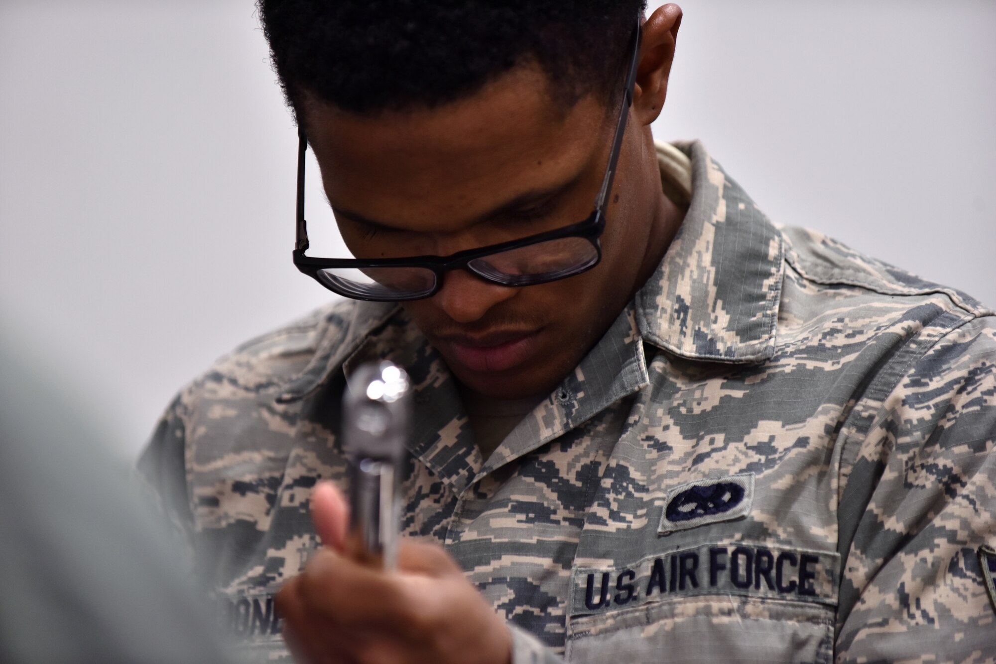 U.S. Air Force Senior Airman Stephen Jones, a composite tool kit technician assigned to the 509th Aircraft Maintenance Squadron, inspects a took before check out in one of the supply buildings at Whiteman Air Force Base, Mo., April 10, 2018. Each tool must have the correct labels and be free of discrepancies before being issuing out to a crew chief for maintenance. (U.S. Air Force photo by Senior Airman Jovan Banks)