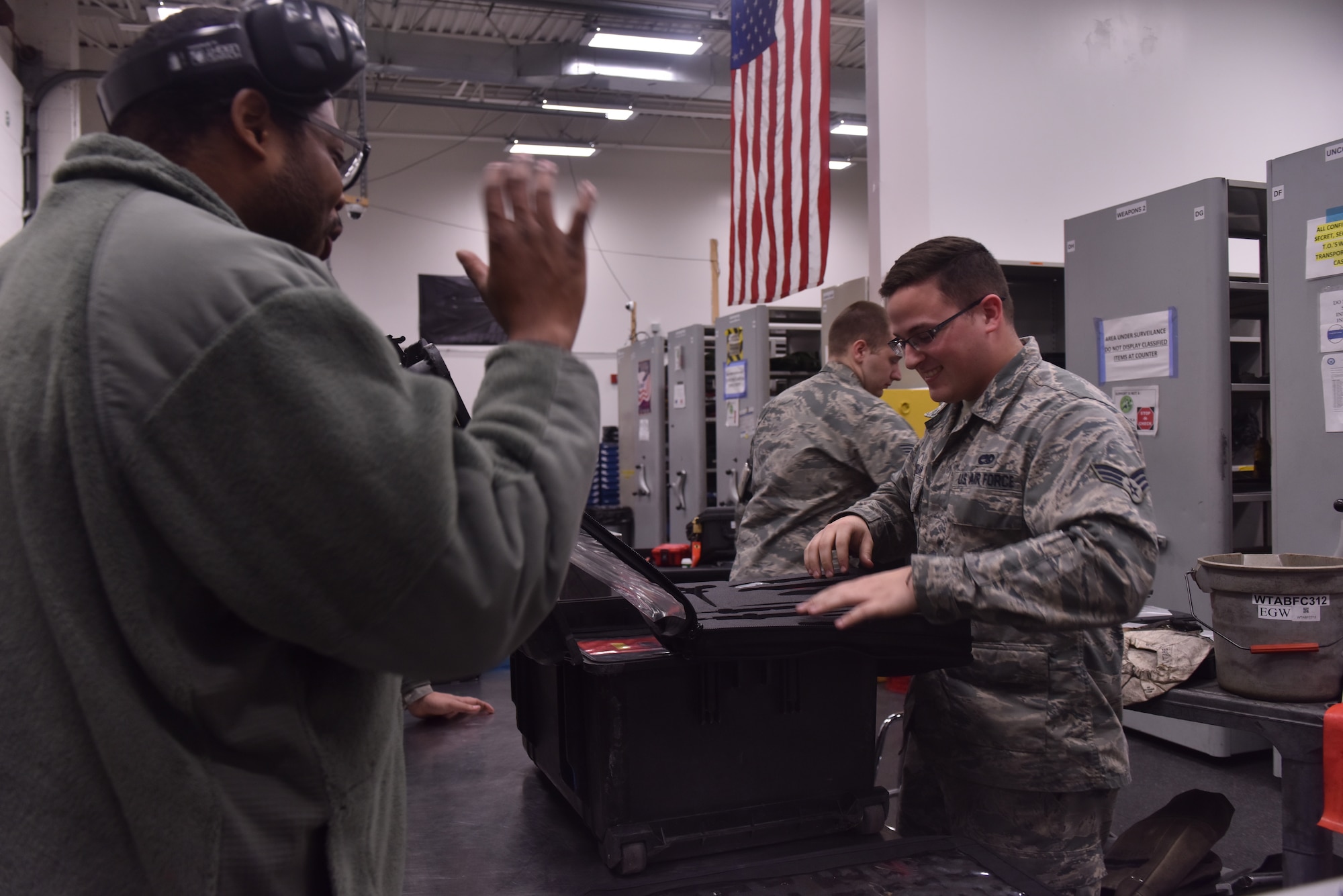 U.S. Air Force Senior Airman Daniel Meehan, a composite tool kit technician assigned to the 509th Aircraft Maintenance Squadron, helps a crew chief check out maintenance tools at Whiteman Air Force Base, Mo., April 10, 2018. In the supply building, the technicians control more than $15 million worth of equipment. (U.S. Air Force photo by Senior Airman Jovan Banks)