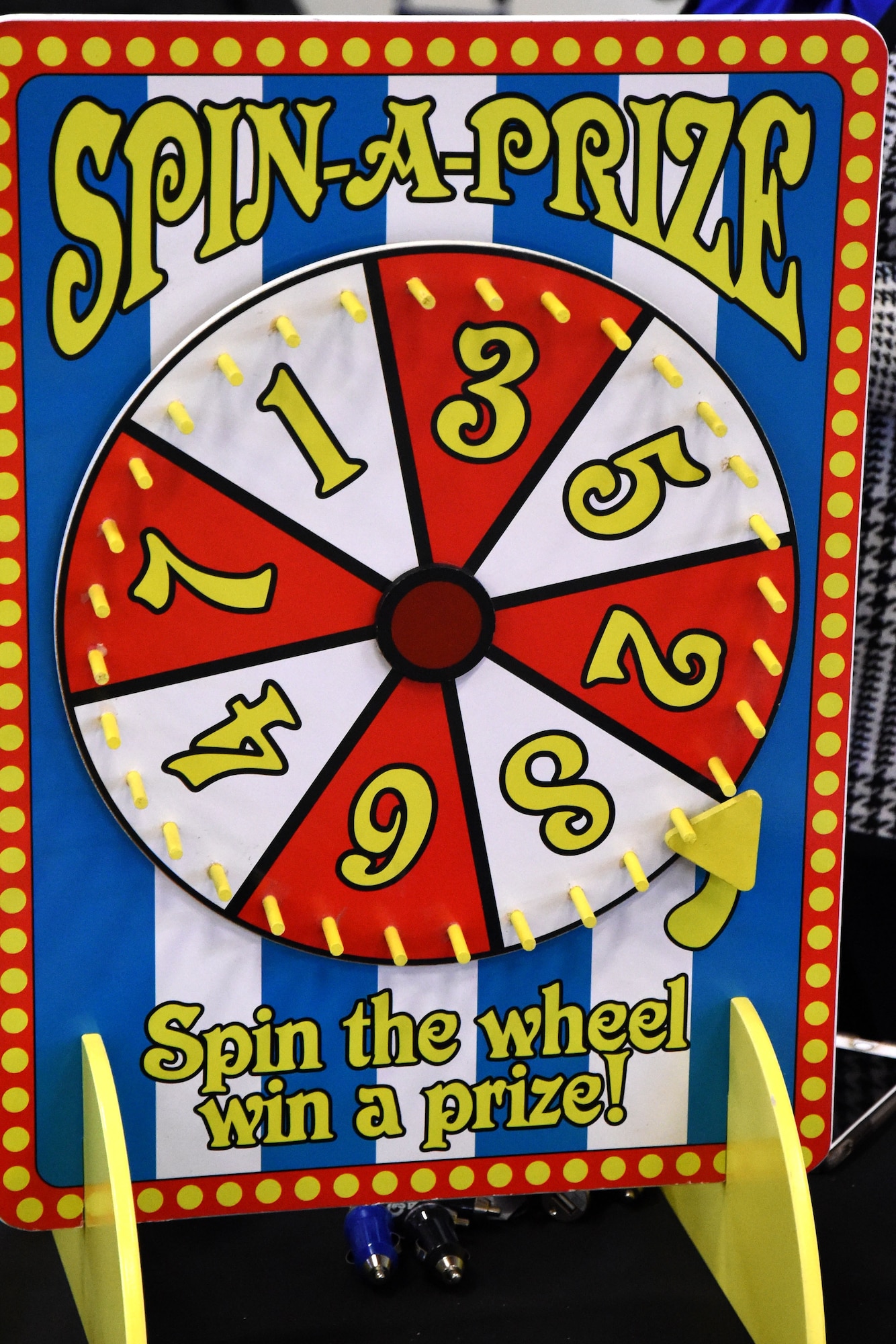 A spin wheel allows members attending the Volunteer Fair to spin for a prize at one of the booths set up at Carswell Field House on Goodfellow Air Force Base, Texas, 
April 11, 2018. Booths and games were set up to inform attendees of the different organizations on and off base. (U.S. Air Force photo by Airman 1st Class Seraiah Hines/Released)