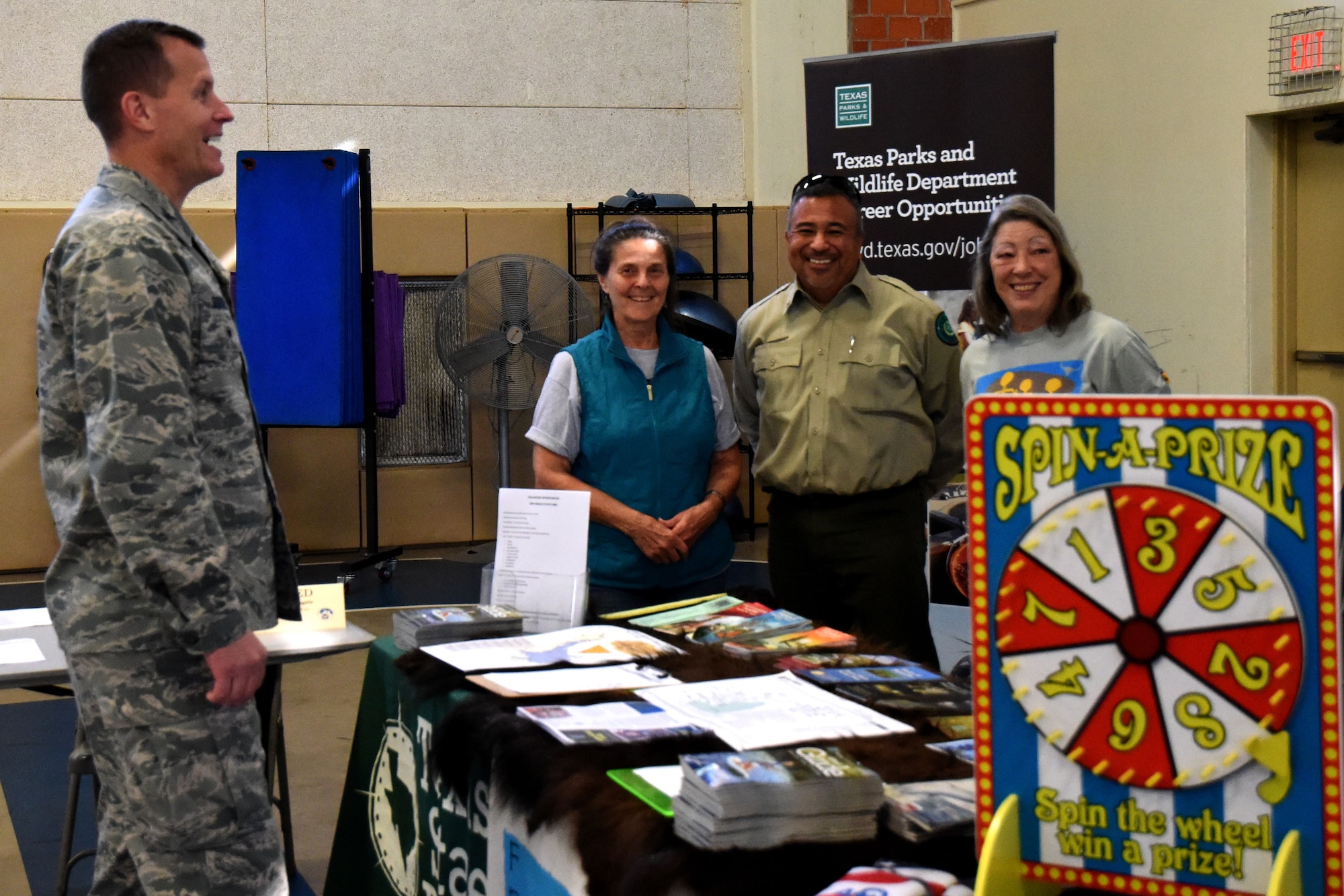 U.S. Air Force Col. Jeffrey Sorrell, 17th Training Wing vice commander, talks with venders at the Volunteer Fair held at Carswell Field House on Goodfellow Air Force Base, Texas, April 11, 2018. Venders from non-profit organizations were able to come and set up booths raising awareness for various volunteer opportunities available to Goodfellow members. (U.S. Air Force photo by Airman 1st Class Seraiah Hines/Released)