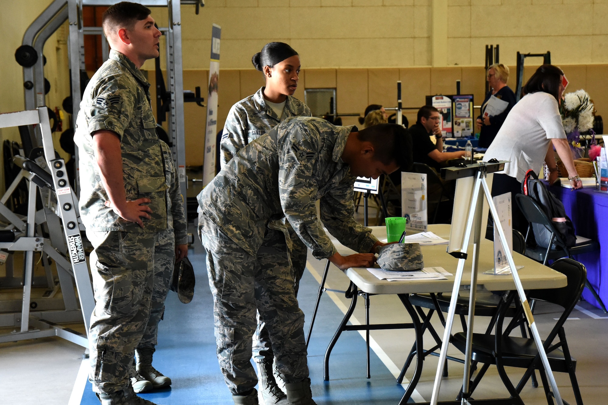 Airmen attending the Volunteer Fair sign in before walking through the various booths set up at Carswell Gym on Goodfellow Air Force Base, Texas, April 11, 2018. Service members, civilians and dependents could attend the Volunteer Fair and learn about the non-profit organizations within the San Angelo community and how to volunteer with them. (U.S. Air Force photo by Airman 1st Class Seraiah Hines/Released)