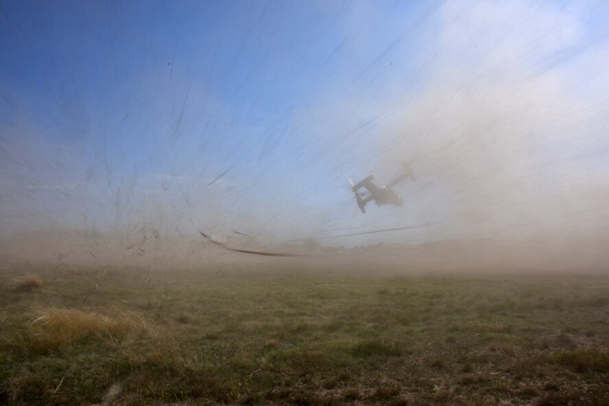 Debris is blasted across the field as the CV-22 Osprey from the 20th Special Operations Squadron takes off from Goodfellow Air Force Base, Texas, April 11, 2018. The Osprey is a tiltrotor aircraft that combines the vertical takeoff, hover and vertical landing qualities of a helicopter with the long-range, fuel efficiency and speed characteristics of a turboprop aircraft. Its mission is to conduct long-range infiltration, exfiltration and resupply missions for special operations forces.