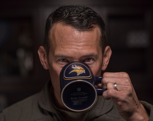 U.S. Air Force Col. Paul Moga, 33rd Fighter Wing commander, takes a sip of coffee from a mug with his favorite sports team's logo April 10, 2018, at Eglin Air Force Base, Fla. Moga is fan of all of the major sports teams from his home state of Minnesota. He uses many of the lessons that can be derived from sports in his daily life as a wing commander.(U.S. Air Force photo by Staff Sgt. Peter Thompson)