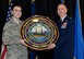 Col. James P. Ryan, retired 157th Air Refueling Wing commander, receives a retirement gift from his son, Staff Sgt. James Ryan, during his retirement ceremony on April 07, 2018 at Pease Air National Guard Base, N.H. Ryan retired after more than 30 years of service. (N.H. Air National Guard photo by Airman 1st Class Victoria Nelson)