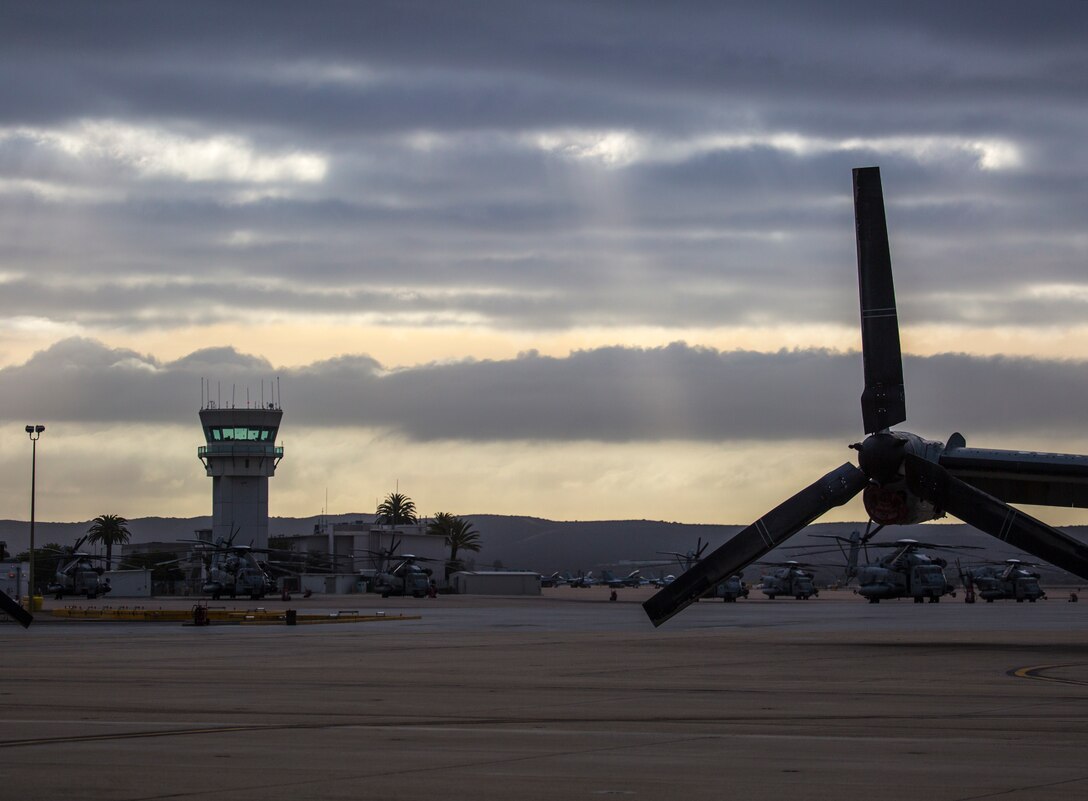 Aircraft with 3rd Marine Aircraft Wing rest on the flight line during sunrise at Marine Corps Air Station Miramar, Calif., April 12. Marine Heavy Helicopter Squadron (HMH) 361, Marine Light Attack Helicopter Squadron (HMLA) 469 and Marine Medium Tiltrotor Squadron (VMM) 166 have consolidated to become VMM-166 (Reinforced) and will support an upcoming combat deployment with the 13th Marine Expeditionary Unit. MCAS Miramar is home to 3rd MAW and 19 of its squadrons. (U.S. Marine Corps photo by Cpl. Becky Calhoun/Released)
