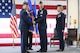Col. Jon A. Eberlan (center), 75th Air Base Wing commander, accepts the wing guidon from Lt. Gen. Lee K. Levy II, Air Force Sustainment Center commander, during a 75th ABW change of command ceremony April 13, 2018, at Hill Air Force Base, Utah. Watching is Col. Jennifer Hammerstedt, formerly the 75th ABW commander. (U.S. Air Force photo by Cynthia Griggs)