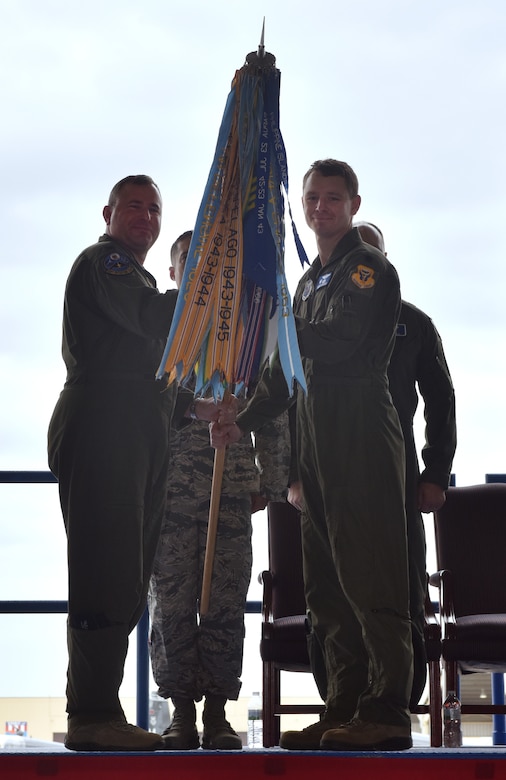 U.S. Air Force Col. Brian Gallo, the 509th Operations Group commander, passes the guidon to Lt. Col. Geoffrey Steeves, as Steeves assumes command of the 13th Bomb Squadron,  at Whiteman Air Force Base, Mo., April 13, 2018. The 394th Combat Training Squadron was inactivated and its personnel shifted over to the 13th Bomb Squadron, which will now serve as the formal training unit for the B-2 Spirit.