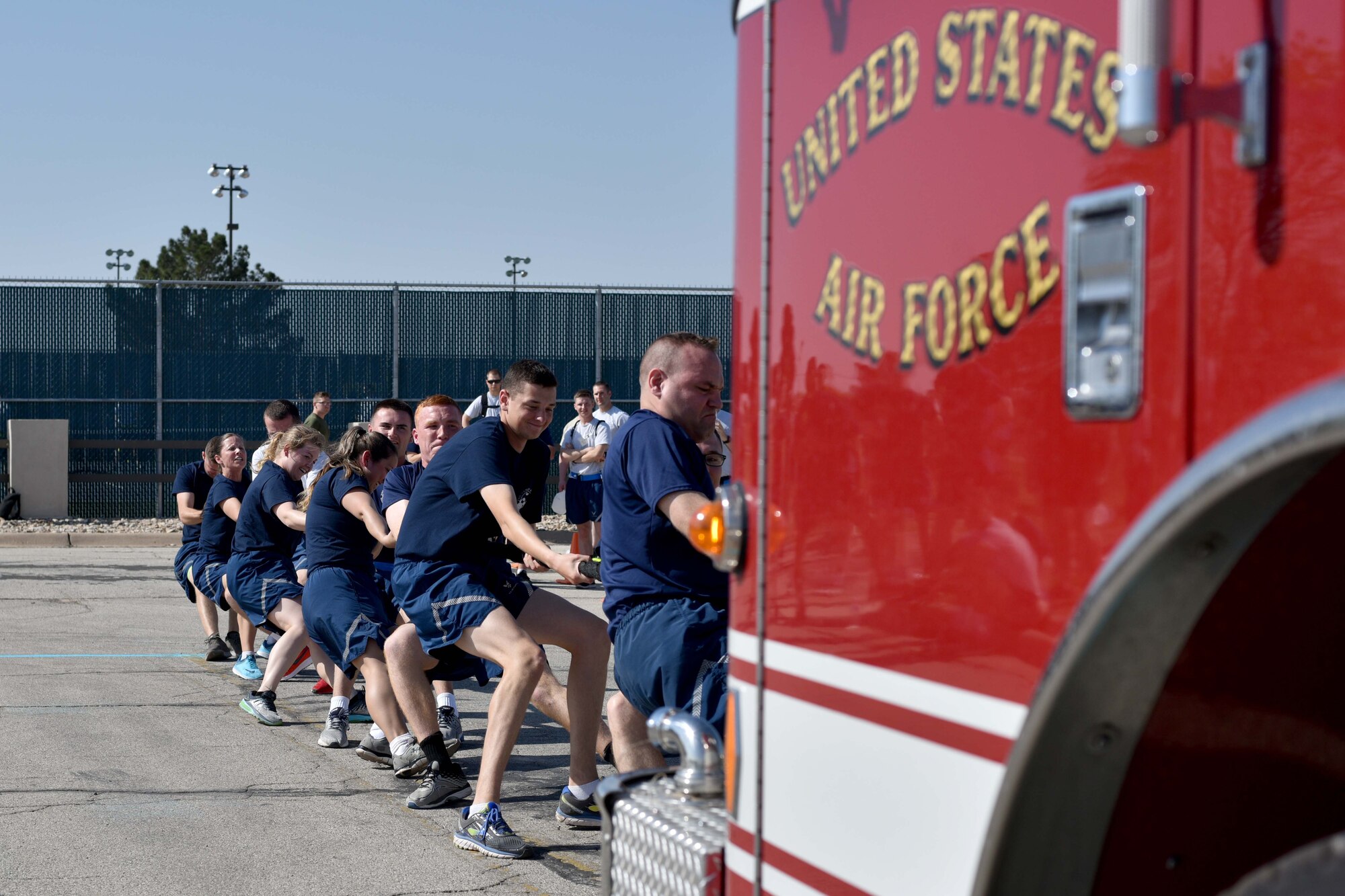 Members from the 35th Training Squadron work together to pull a firetruck during Sports Day at the Mathis Fitness Center on Goodfellow Air Force Base, Texas, April 13, 2018. An average firetruck may weigh 19 Tons, or 41,887 pounds.