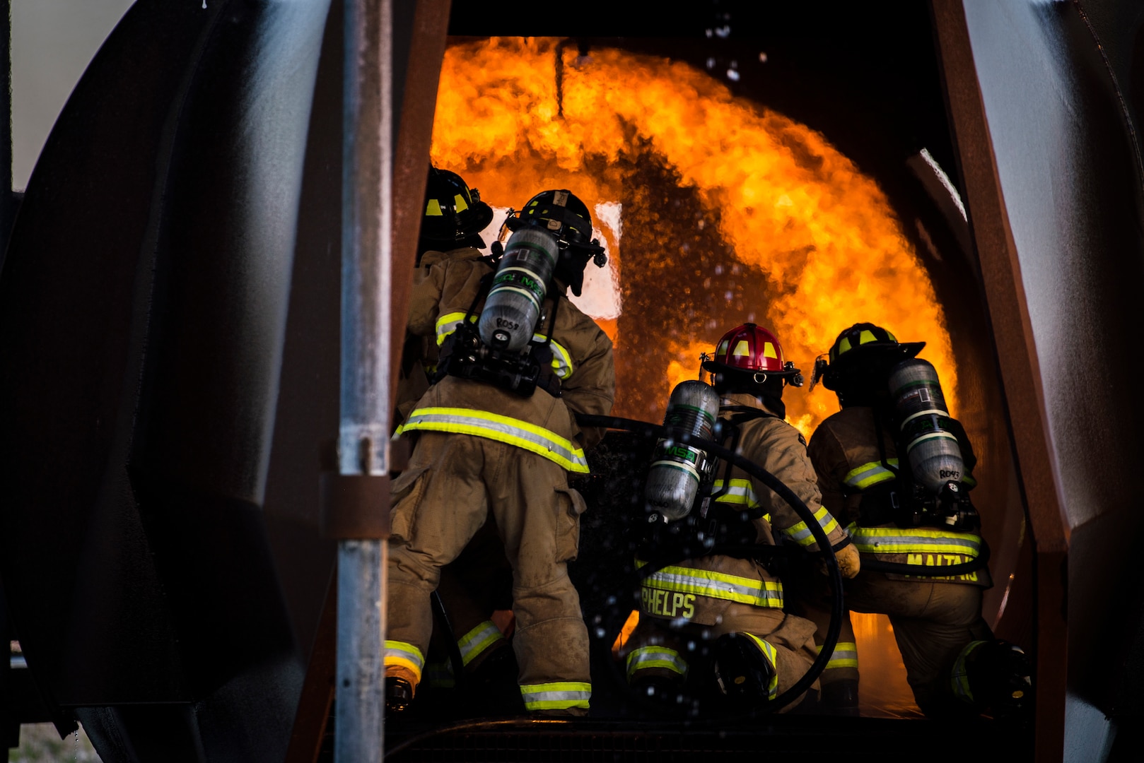 Firefighters from Joint Base San Antonio-Randolph extinguish a fire during training April 11, 2018 at the Camp Talon fire training grounds on JBSA-Randolph. The training takes place quarterly and offers an opportunity for new firefighters to become more confident while fighting fires, but it also gives seasoned Airmen a chance to sharpen their skills and get a head start to the next step in their careers. (U.S. Air Force photo by Senior Airman Gwendalyn Smith)