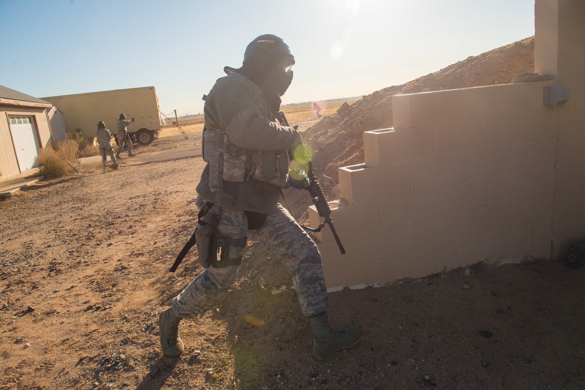 An Airman from the 56th Contracting Squadron takes cover during an exercise Feb. 23, 2018, at Luke Air Force Base, Ariz. The exercise prepared their Airmen to deploy in support of any wartime or peacetime emergency. (U.S Air Force photo by Airman 1st Class Caleb Worpel)