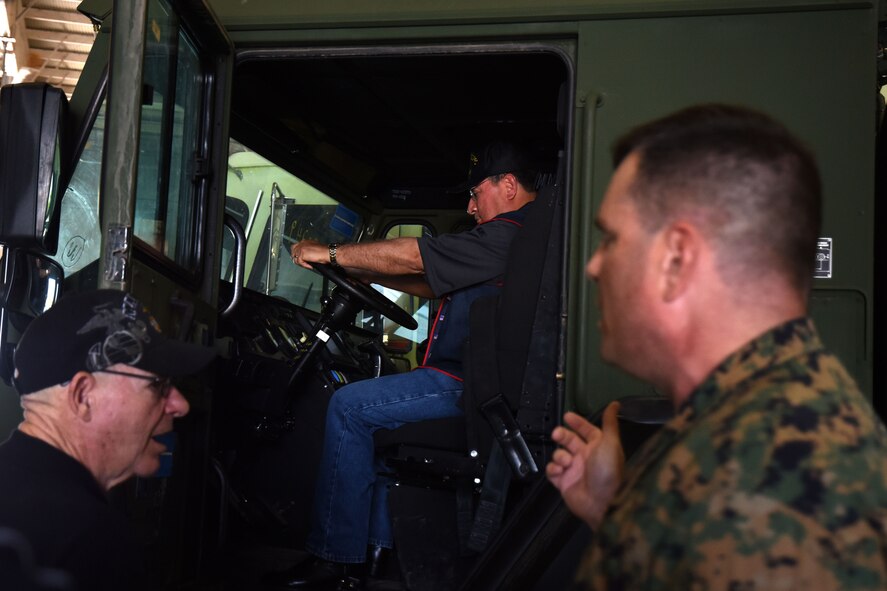 U.S. Marine Corps Master Sgt. Raymond Secoy, staff non-commissioned officer in charge of the Marine Fire School, educates members from the Texas chapter of the 3rd Marine Division Association on the Marine specific fire engine in the Louis F. Garland Department of Defense Fire Academy high bay on Goodfellow Air Force Base, Texas, April 13, 2018. Members were able to explore various parts of the engine and sit in the driver seat if they chose. (U.S. Air Force photo by Airman 1st Class Seraiah Hines/Released)