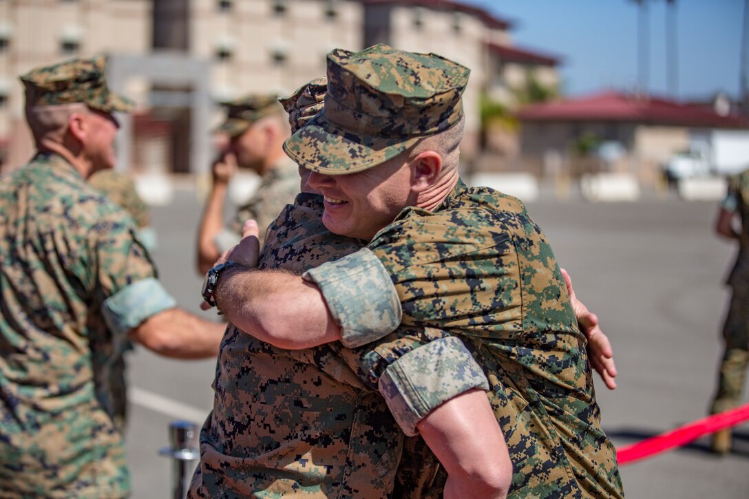 Lt. Col. William Gorsuch, right, commanding officer of I Marine Expeditionary Force Support Battalion hugs another Marine after the activation ceremony conducted on Camp Pendleton, Calif., April 11, 2018. The newly formed MSB will assume the responsibilities of administrative support to the I MEF Command Element to better posture the I MEF Information Group to focus on leading in the information environment. (U.S. Marine Corps photo by Cpl. Jacob A. Farbo)
