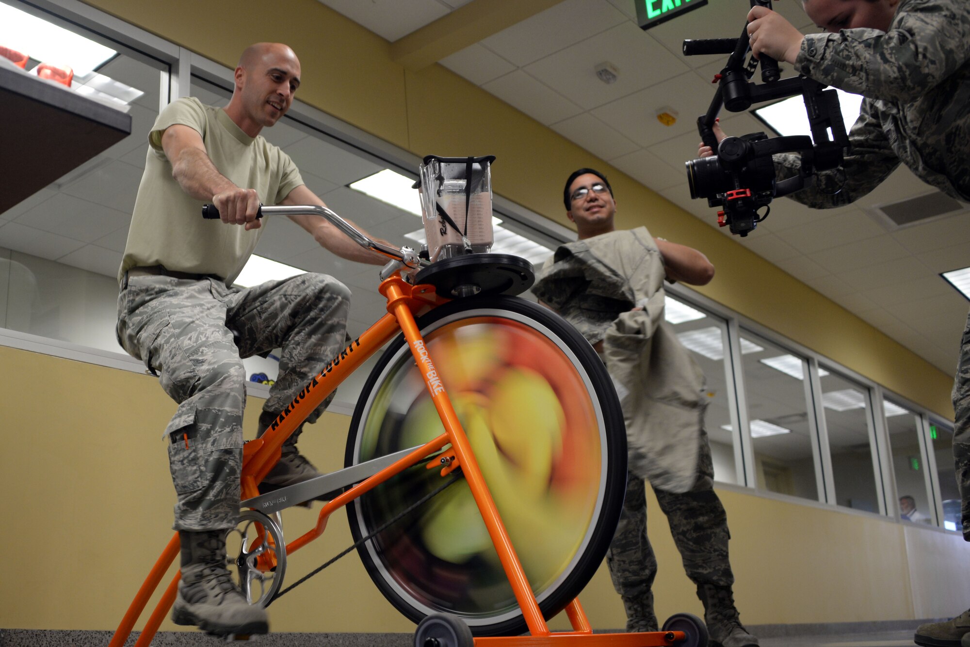 Airmen from the 62nd Aircraft Maintenance Unit participate in blending their own smoothie on a smoothie bike presented by the 56th Medical Group health promotions at Luke Air Force Base, Ariz., April 5, 2018.  The 56th MDG is celebrating National Nutrition Month by inspiring Thunderbolts to eat healthier and promoting overall wellness. (U.S. Air Force photo by Senior Airman Devante Williams)
