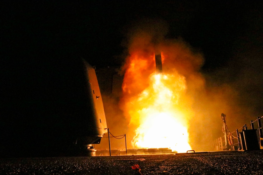 A guided missile cruiser fires a Tomahawk missile.