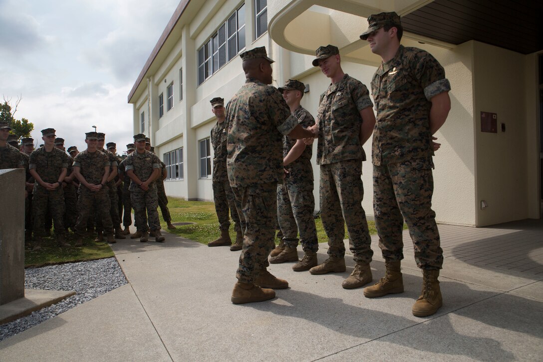 3rd Marine Division Commanding General Maj. Gen. Craig Q. Timberlake presents an appreciation coin to U.S. Marines and Sailors attached to 3rd Marine Division April 13, 2018, on Camp Schwab in Okinawa, Japan. The service members competed in the 2018 Marine Corps Forces Special Operations Command Raider Games March 18-27. The four man team finished 2nd place out of nine other teams that competed.
