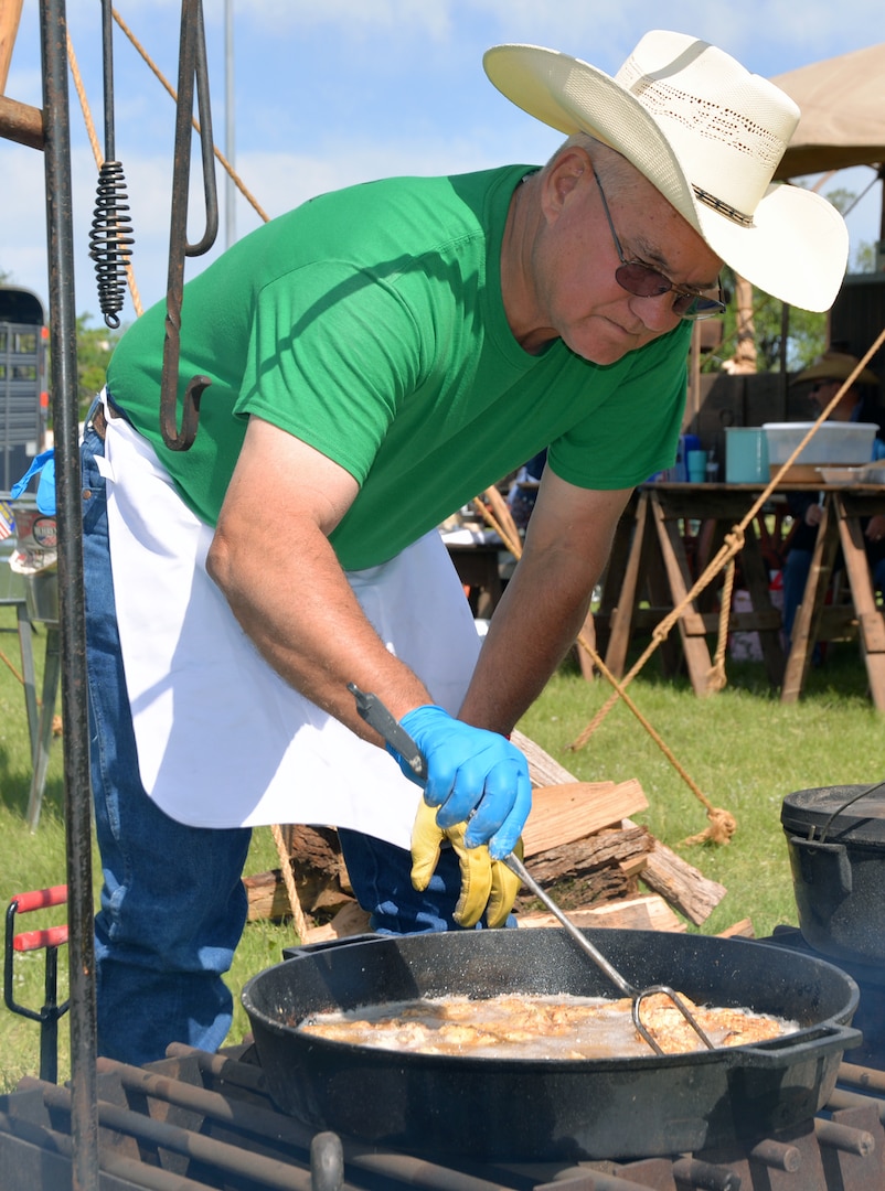 Melvin Mayo from the Cedar Top Chuckwagon out of Terell, Texas, watches over some chicken fried steak during the annual Cowboys and Heroes event held at MacArthur Parade Field at Joint Base San Antonio-Fort Sam Houston April 14.