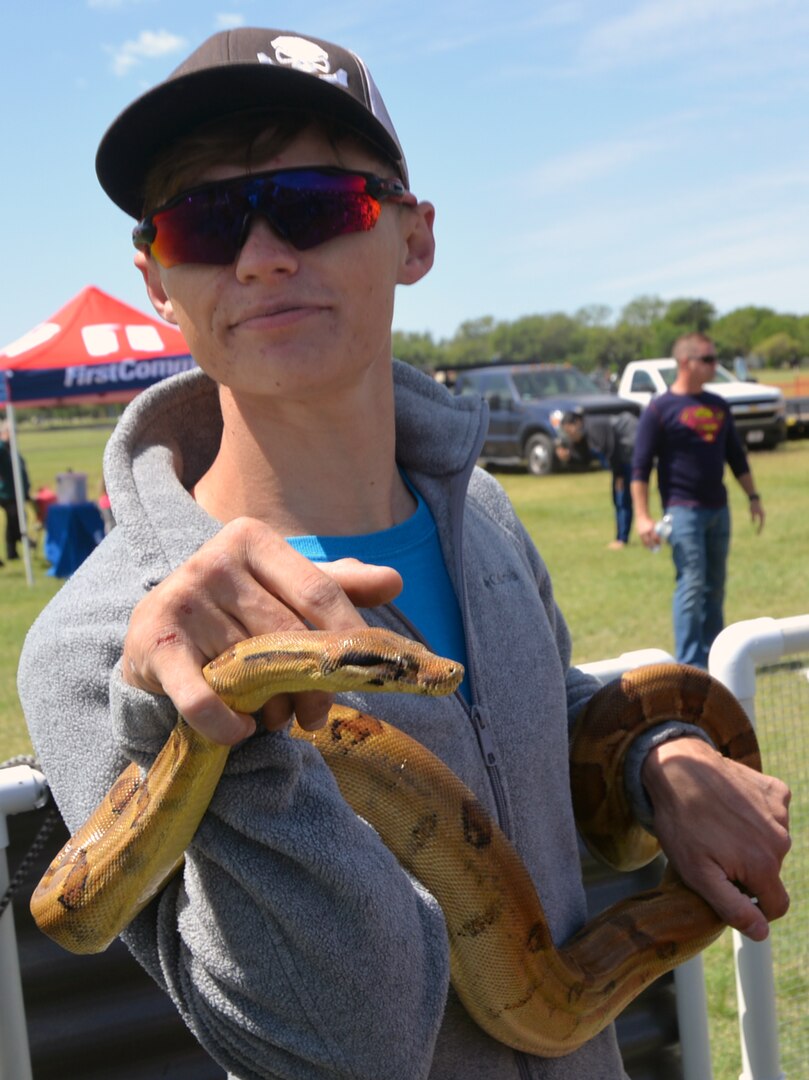 Ssssssay hello to Charlie the boa constrictor, one of the attractions at the petting zoo at the annual Cowboys and Heroes event held at MacArthur Parade Field at Joint Base San Antonio-Fort Sam Houston April 14.
