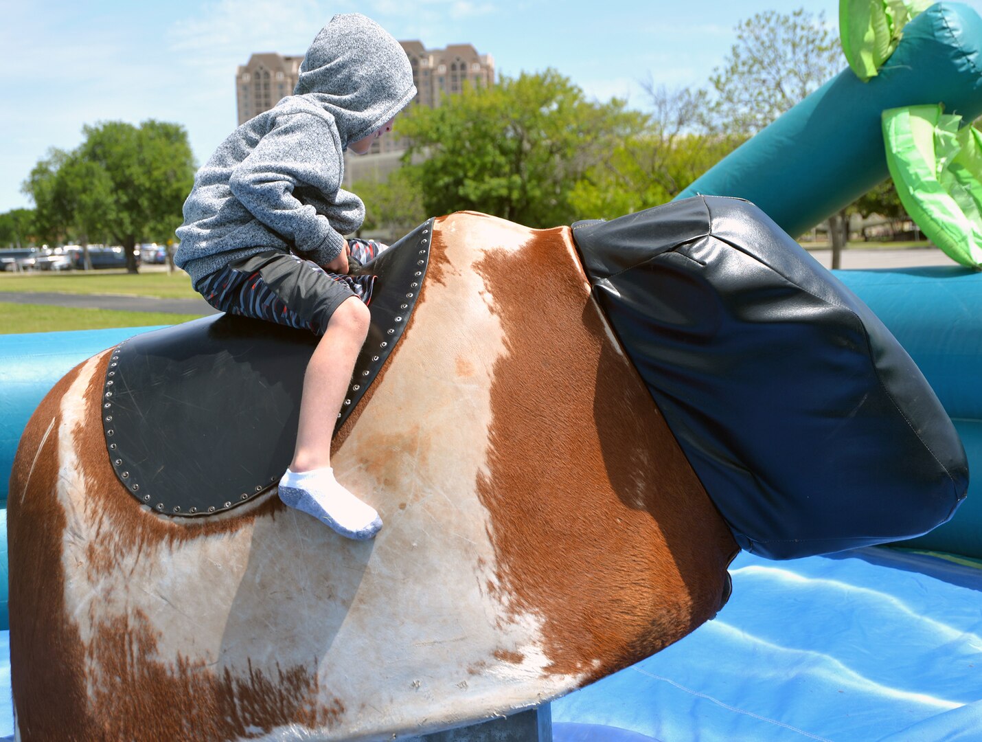 A young would-be bull rider clings on for dear life on a mechanical bull during the annual Cowboys and Heroes event held at MacArthur Parade Field at Joint Base San Antonio-Fort Sam Houston April 14.