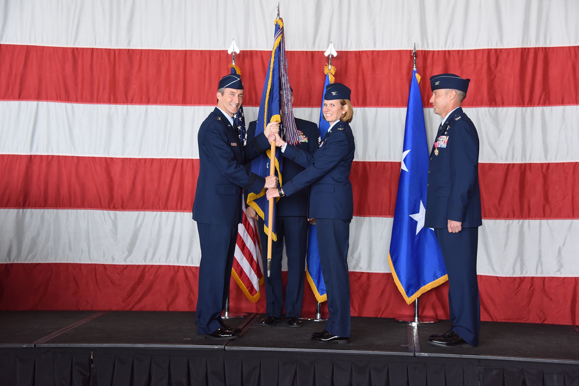 Col. Regina “Torch” Sabric, 419th Fighter Wing commander, accepts the wing flag from Maj. Gen. Ronald Miller, 10th Air Force commander, during a change of command ceremony April 14, 2018, at Hill Air Force Base, Utah.