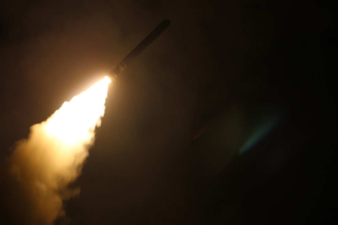 A missile launches at night.