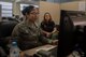 U.S. Air Force Airman 1st Class Leann Munoz, 18th Force Support Squadron customer service technician, makes a dependent identification card for Rebecca Sneller, spouse of retired Army Reserve Chaplain Deric Sneller Mar. 29, 2018, at Kadena Air Base, Japan. The 18th FSS Military Personnel Section implemented a new process that enables customers to file for a dependent identification card from their cell phones or personal emails. The new system saves customers time and enables the MPS to complete more tasks. (U.S. Air Force photo by Staff Sgt. Micaiah Anthony)