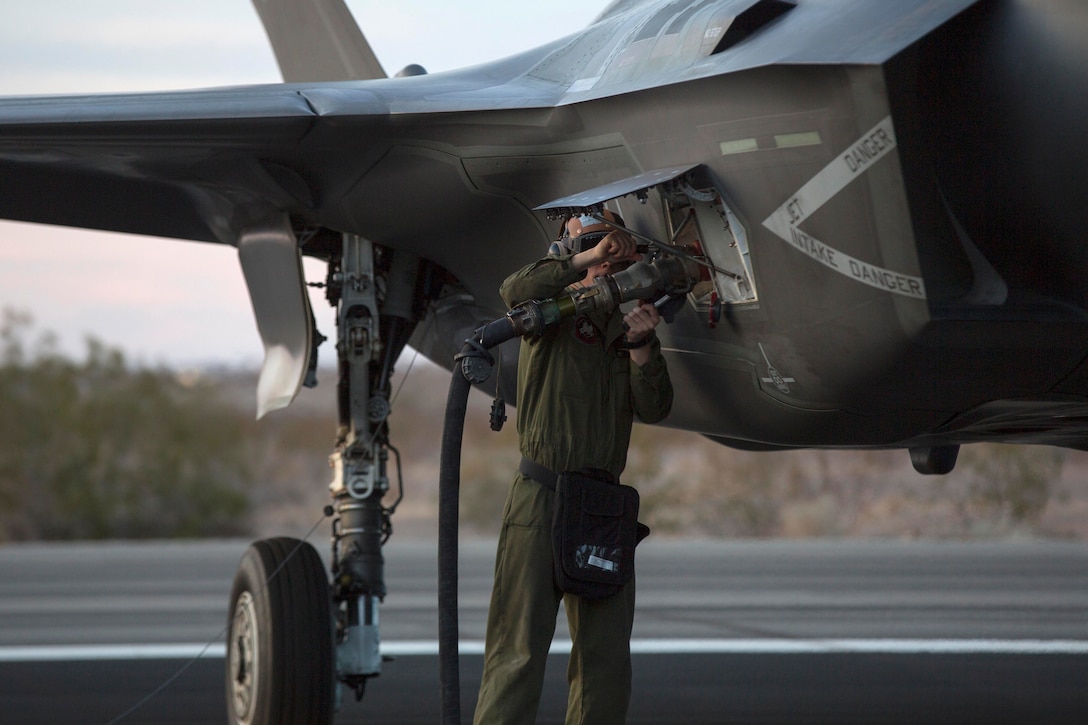 A Marine refuels an F-35 Lightning II aircraft.