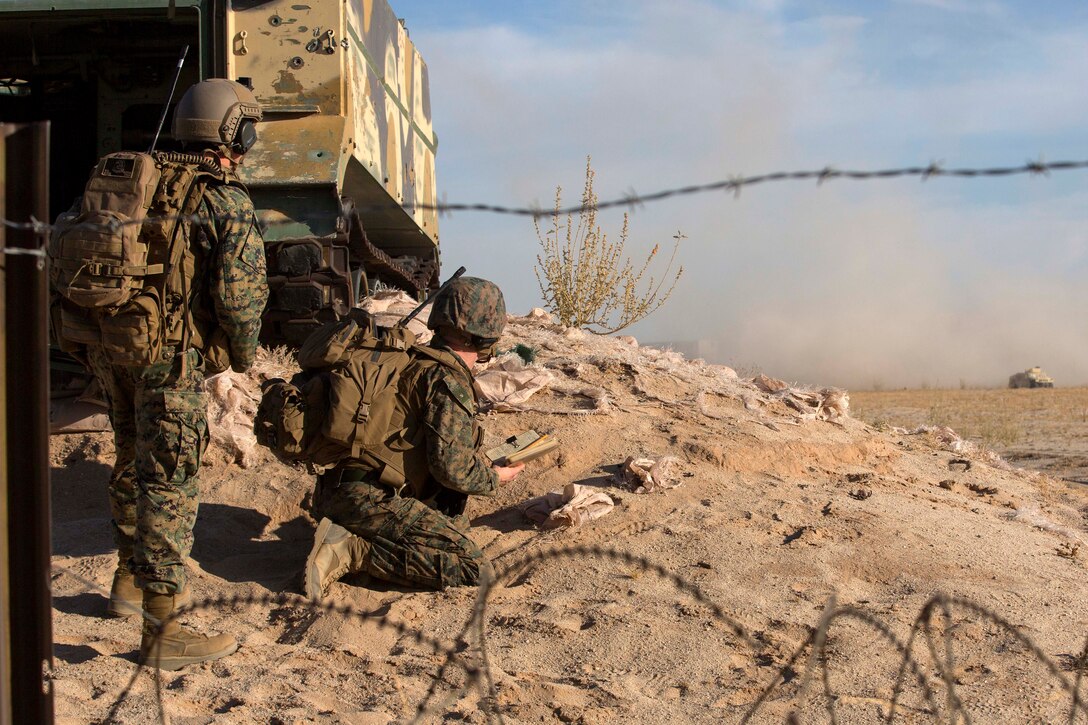 Marines observe attacks on simulated enemy targets.