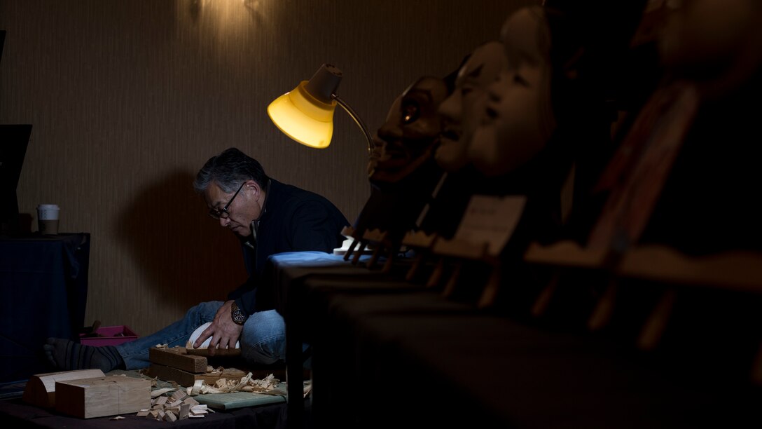 Suwanat Kazuo, a mask artist, carves a mask during the 31st Annual Japan Day at Misawa Air Base, Japan, April 14, 2018. Hirotoshi Mikami started the 31-year-old tradition which included 50 host nation organizations and more than 500 performers, artists and craftsmen. The base-wide celebration gave Team Misawa a chance to experience authentic Japanese culture. (U.S. Air Force photo by Airman 1st Class Collette Brooks).