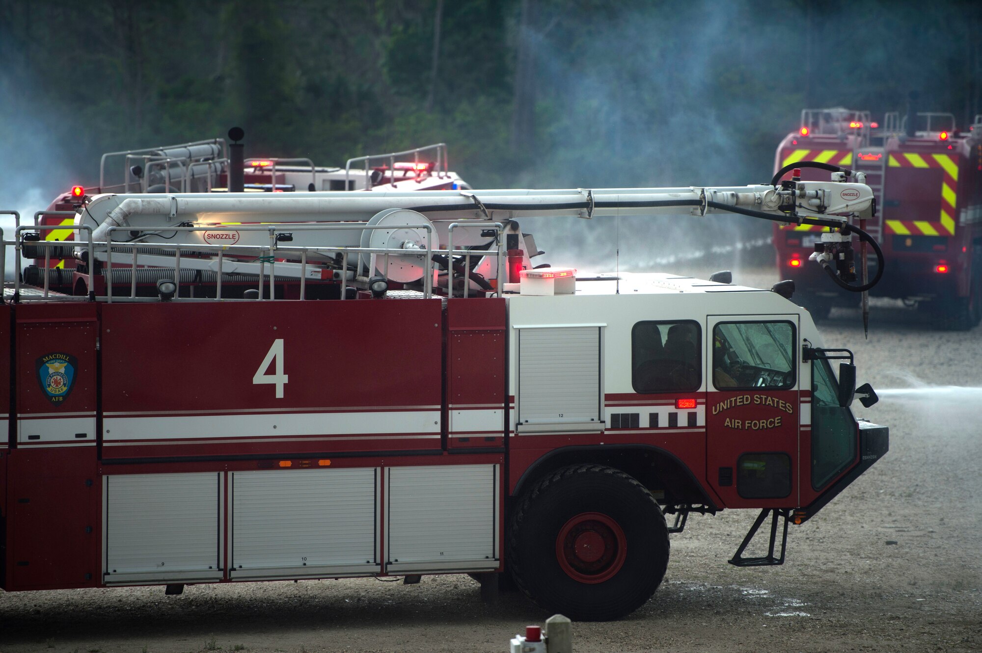U.S Air Force Airmen assigned to the 6th Civil Engineer Squadron at MacDill Air Force Base, Fla, spray three separate fires simultaneously during an emergency response exercise April 10, 2018.